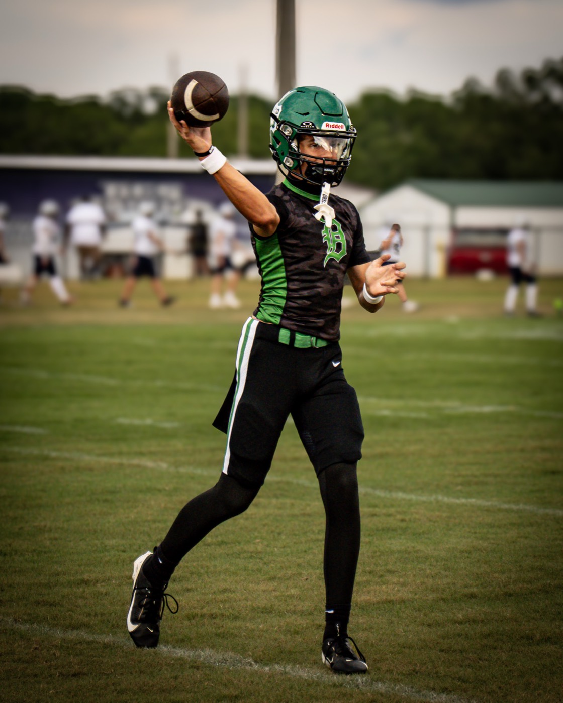 Dixie Hornets quarterback throwing during warmups