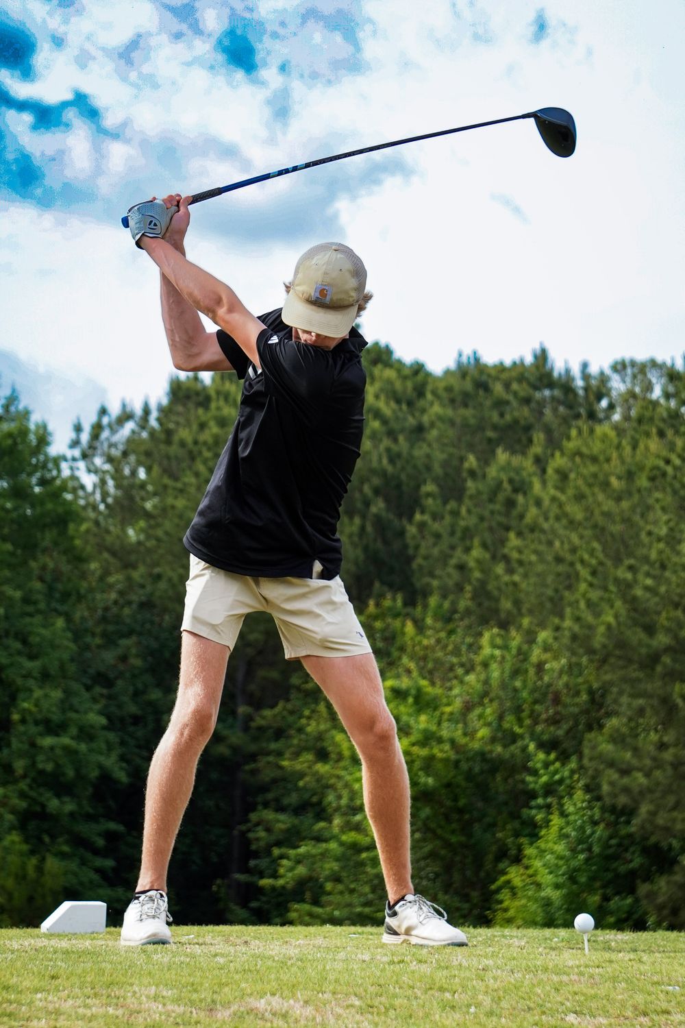 High school golfer at the tee box during a match in Greenwood, South Carolina