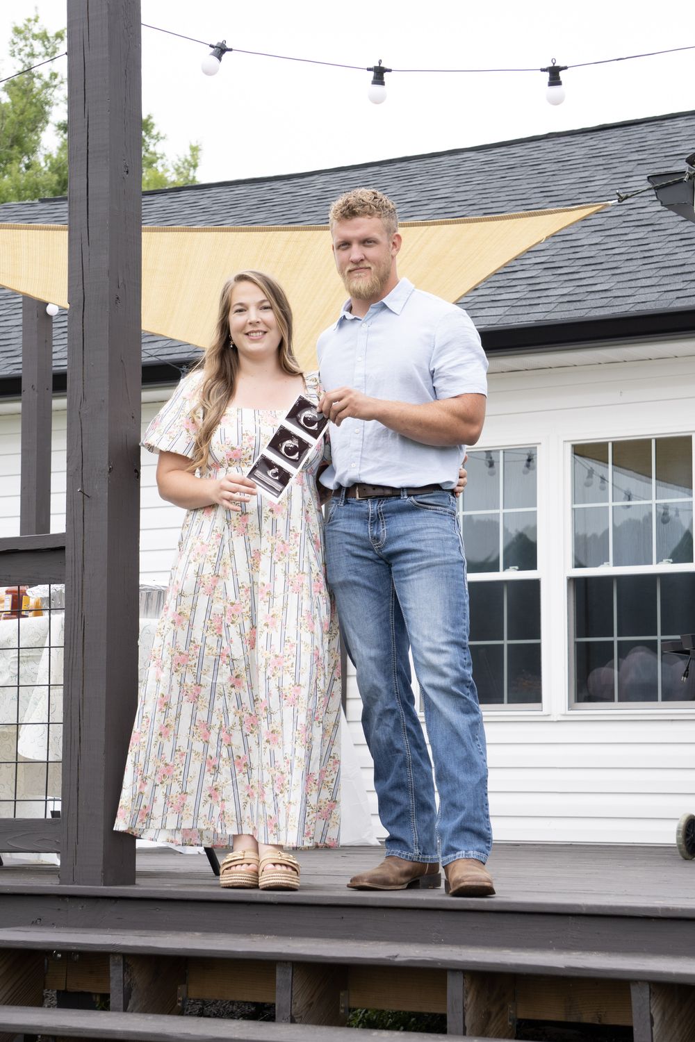 Couple announcing big news during a portrait session in Greenwood, SC